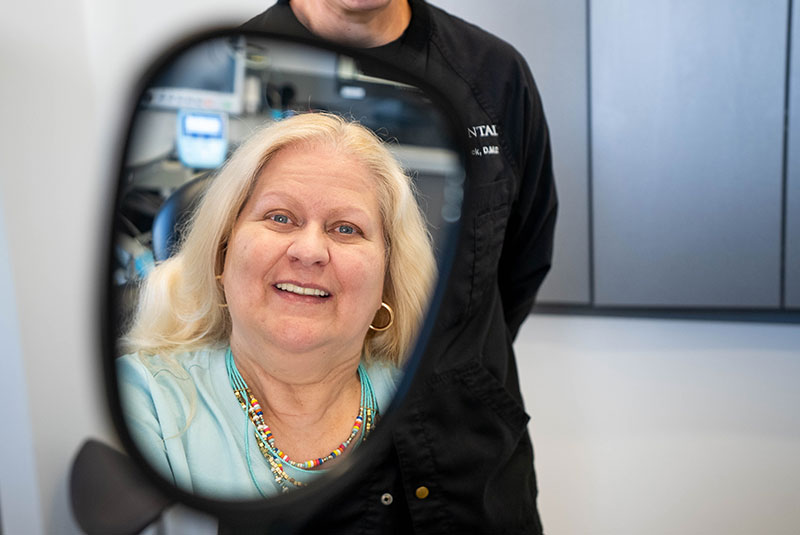 dental implant Paitent looking into mirror after dental implant procedure