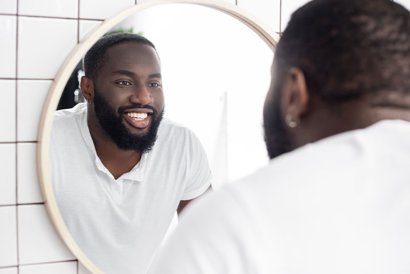 Man smiling in mirror