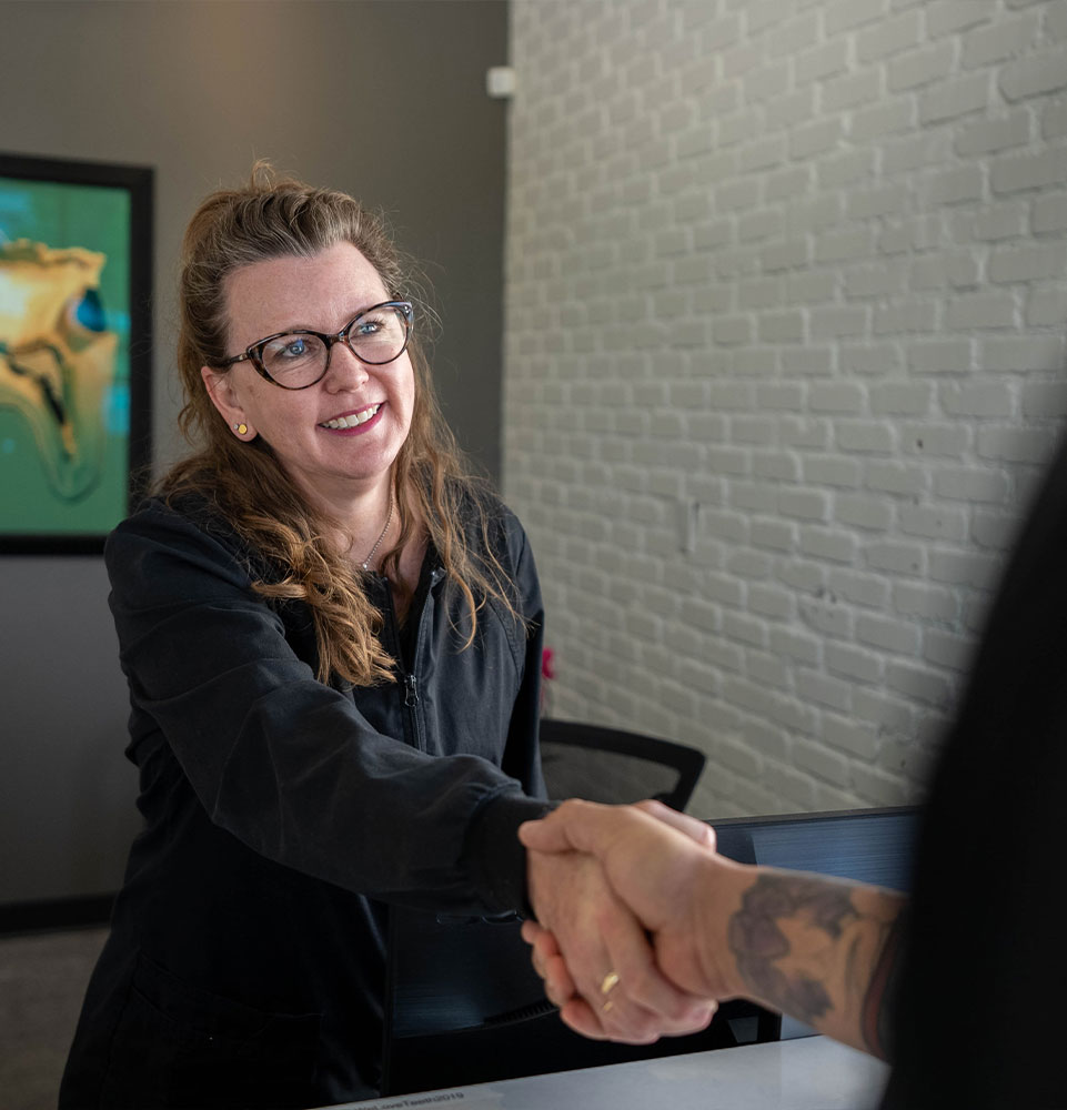 team member shaking patients hand