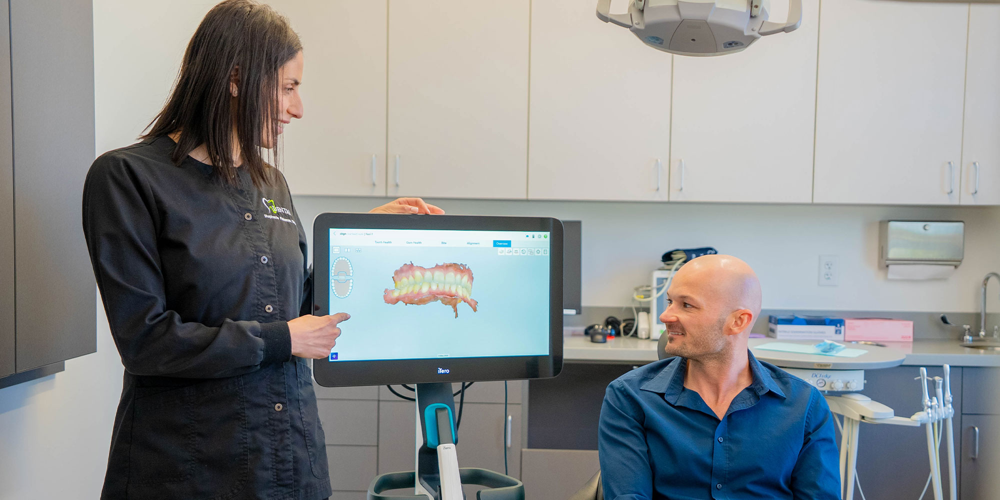 dentist going over 3d scan with patient