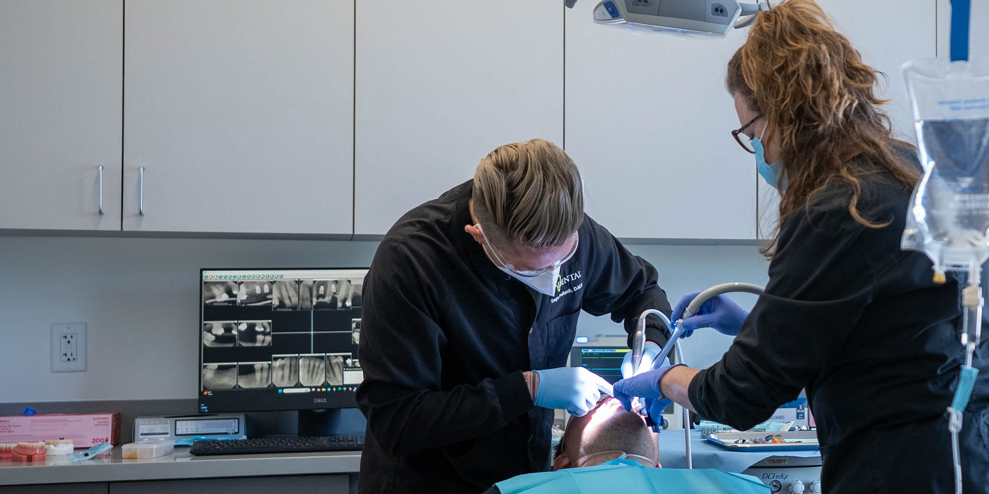 Dentisti and the middle of a dental procedure